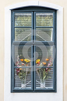 Window of a romantic and colorful house with flower pots