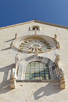 Window and rose window on west facade of Trani Cathedral