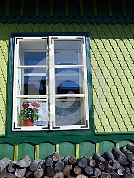 Window of a sculpted and decorated green wood house of Romania.