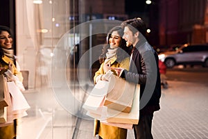 Window shopping. Young couple looking at showcase