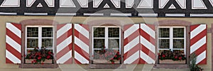 Window shutters in red and white. Panorama