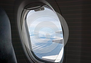 Window side of passenger with wing airplane flying