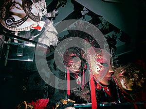 Window of a souvenir shop in Venice with red and gold masks