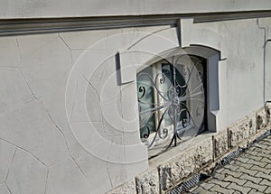 window with spiral-shaped security grille. in the basement photo