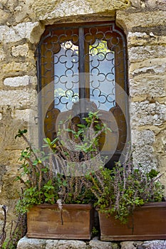 Window in the stone wall. Eze village at french Riviera coast Provence, France