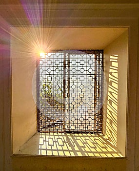 A window with a sun shining through it