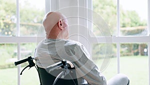 Window, thinking and senior man in wheelchair and anxiety for healthcare, retirement and surgery. Nursing home, mental