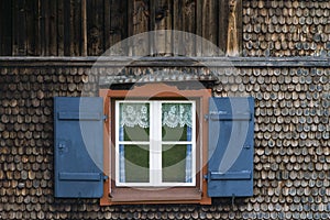 Window at a typical old bavarian farmhouse in the alps.