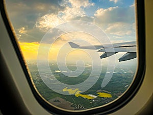 Window view from inside the aircraft while flying above beautiful landscape