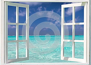 Window with view to turquoise waters and blue skies