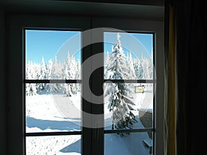 Window view in a winter mountain resort