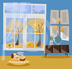 Window with a view of yellow trees and flying leaves. Autumn interior sleeping cat and dog on pillow, shelf, vase with branches.