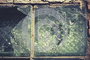 A window in a wall of broken glass blocks