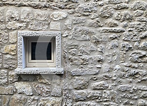 Window on the wall of an old house