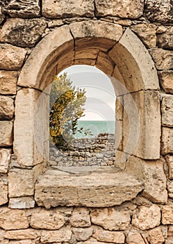 Window in the wall. The ruins of ancient Greek city of Chersonesus Taurica in the Crimea peninsula under the cloudy sky