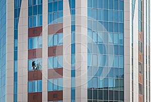 Window washer in skyscrapers. Industrial alpinism. Unusual work