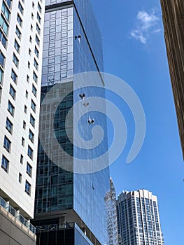 Window washers hanging from skyscaper in Chicago, Illinois