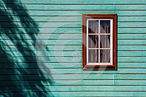 Window on weatherboard cabin wall.