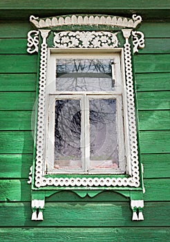 Window with white trim on the green wall