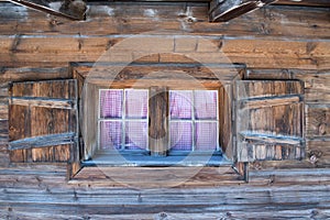 Window of a wodden hut in Austria photo