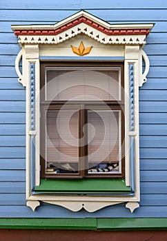A window at a wooden house with a platband in the colors of national Tatar traditions in Kazan, Russia