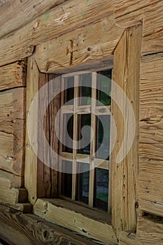 Window in a wooden house. wooden house with window frame. Old wooden house in the village, Wood board background, texture. Window