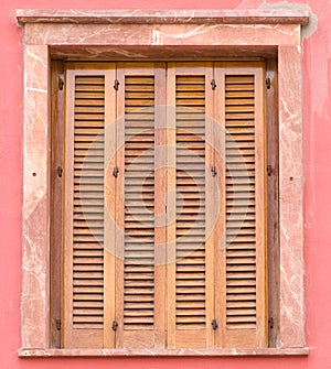 Window with wooden louver shutters