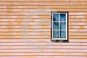 Window on wooden weatherboard wall.