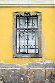 Window on yellow wall