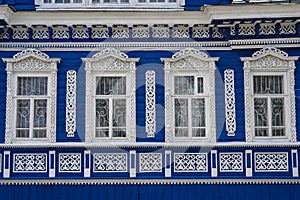 Windows of a 19th century wooden house with carved platbands in Gorodets, Russia