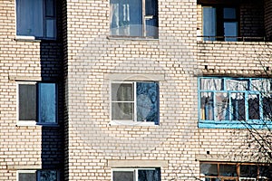 Windows of apartments on brick wall of house