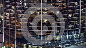 Windows in apartments of a high class building at night timelapse