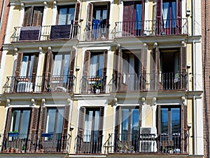 Windows and balconies on aged apartment building block in Lavapies district, Madrid, Spain