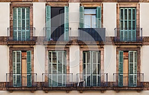 Windows and balconies in row on facade of historic building