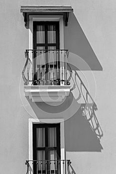 Windows with balcony on building facade with cast iron ornaments , Turkey. Black and white