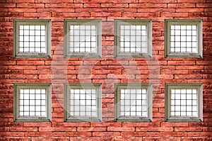 windows with bars of iron on red old brick wall