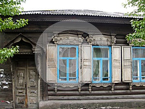 The windows with beautiful architraves in old wooden house. Ulan-Ude.