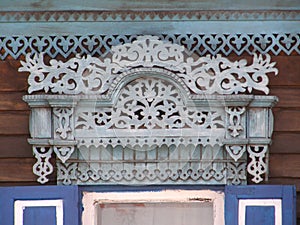 The windows with beautiful architraves in old wooden house. Ulan-Ude.