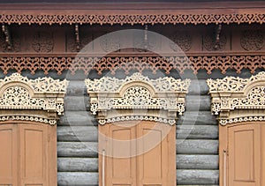 The windows with beautiful architraves in old wooden house. Ulan-Ude.