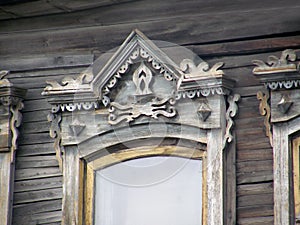 The windows with beautiful architraves in old wooden house. Ulan-Ude.