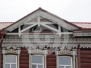 The windows with beautiful architraves in old wooden house. Ulan-Ude.