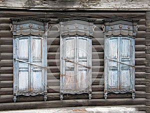 The windows with beautiful architraves in old wooden house. Ulan-Ude.