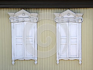 The windows with beautiful architraves in old wooden house. Ulan-Ude.