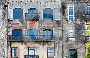 Windows and Black Iron on Old Brick Wall