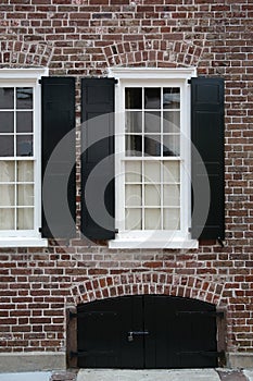 Windows, brick wall, black shutters