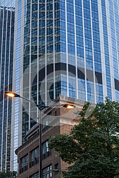 Windows of business office building with street lamp at front, Corporate buildings in city