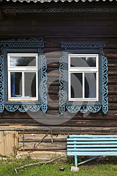 Windows with carved frames and shutters in village houses photo