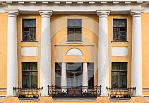 Windows, columns and balconies on facade of apartment building