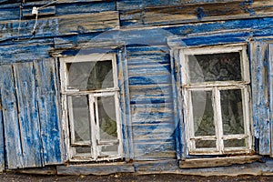 Windows of a dilapidated rickety old wooden house