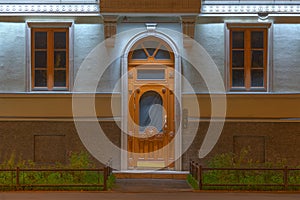 Windows and door on night facade of apartment building